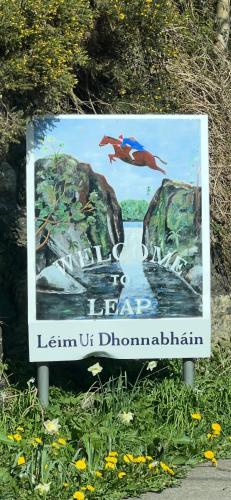 a sign with a picture of a river and a bird at Holiday Home in Leap in Leap