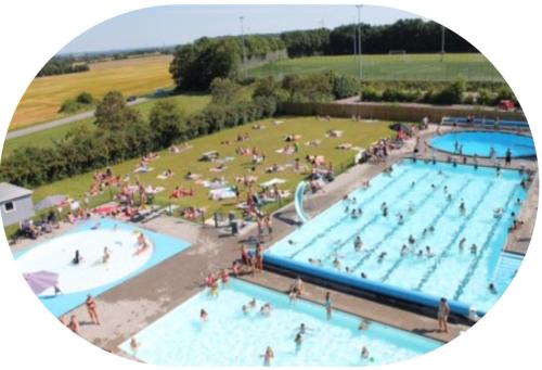 a group of people swimming in two swimming pools at Privat lejlighed på landejendommen Frederiks-Eg in Herlufmagle