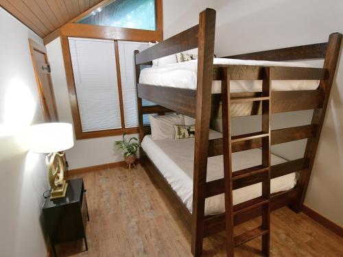 a bunk bed room with two bunk beds and a window at Abe Martin Lodge & Cabins in Nashville