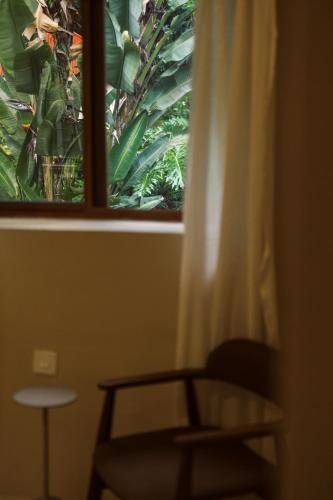 a window with a chair and a table in a room at Tulia Retreat Hotel and Spa in Arusha