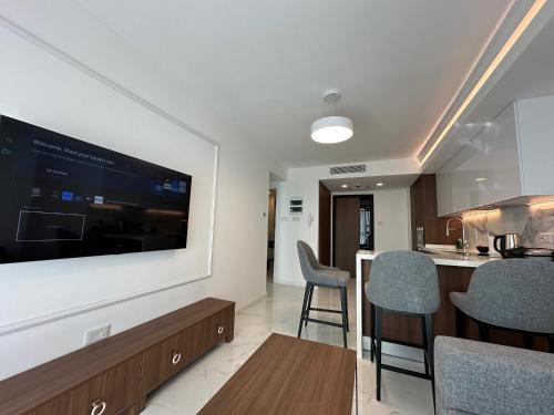 a living room with a large flat screen tv on a wall at Grand Sapphire Luxury Residence By MyGuest Cyprus in Iskele