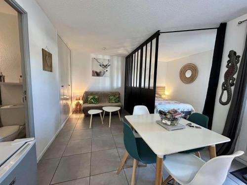 une pièce avec une table, des chaises et un lit dans l'établissement Appart studio 4 couchages SAINT CYPRIEN SC245-004, à Saint Cyprien Plage