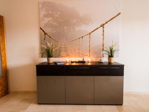 a desk in a room with candles and a painting at Apartment RoSol Albir Playa in Albir