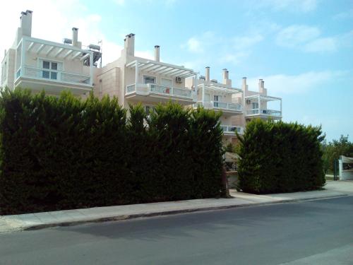 a large white building on the side of a street at Cybele Guest Accommodation in Athens