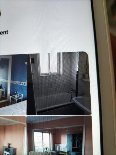 une vue d'une salle de bain avec un lavabo et une baignoire dans l'établissement Appartement vue mer, à Berck-sur-Mer