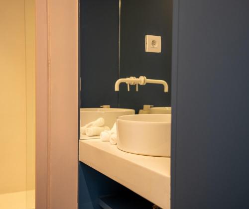 a bathroom with a sink and a mirror at Neo Suites in Fira