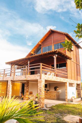 a house with a gambrel roof at Pousada Rancho Matos in Santo Amaro