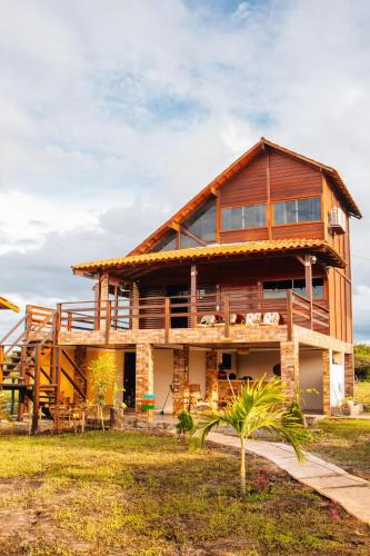 a large wooden house with a roof at Pousada Rancho Matos in Santo Amaro