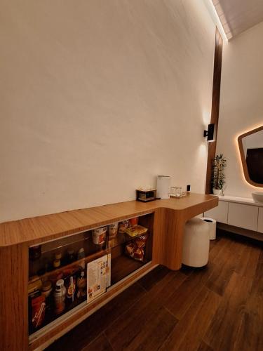 a room with a wooden counter with food on it at Pondok Wisata Istana XI in Medan