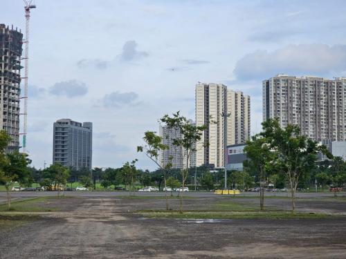 an empty parking lot in a city with tall buildings at Apartemen B Residence By LiviRooms BSD CITY in Cilandak