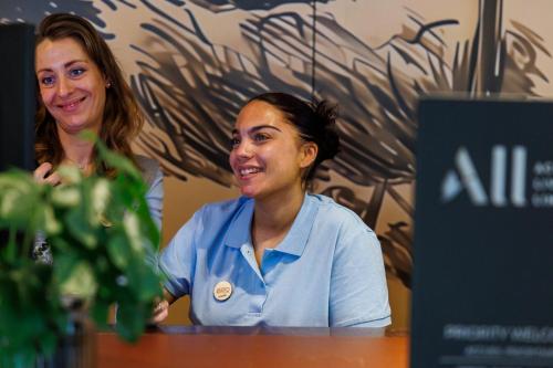 two women sitting at a table in a room at Adagio Nice Centre in Nice