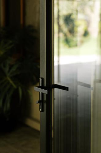 a sliding glass door with a metal latch on it at Tulia Retreat Hotel and Spa in Arusha