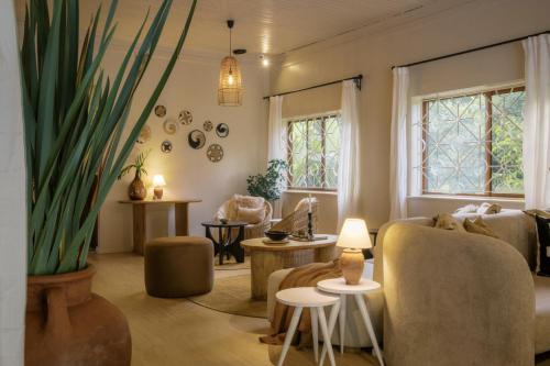 a living room with a couch and a potted plant at Tulia Retreat Hotel and Spa in Arusha