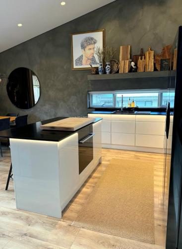 a kitchen with a black and white counter top at Luxury row house in quiet area with infrared sauna and hot tub in Mosfellsbær
