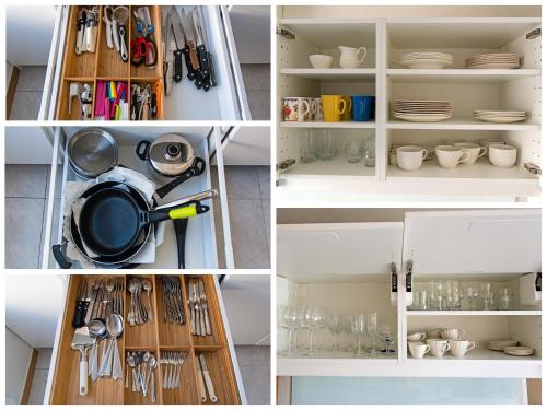 a kitchen cabinet with utensils and dishes in it at Apartment RoSol Albir Playa in Albir