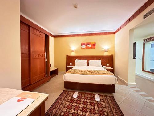 a bedroom with a large bed in a room at Romance Regency Club in Sharm El Sheikh