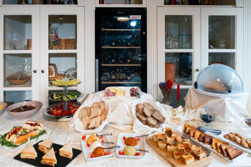 a table topped with lots of different types of food at Casa del Sole Boutique Hotel Timisoara in Timişoara