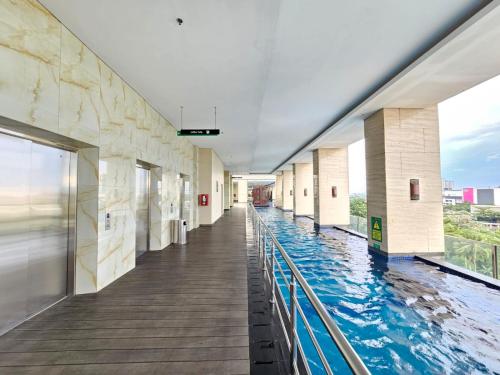 a swimming pool in a building with a view at Apartemen B Residence By LiviRooms BSD CITY in Cilandak