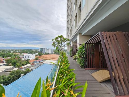 a balcony with a swimming pool on a building at Apartemen B Residence By LiviRooms BSD CITY in Cilandak