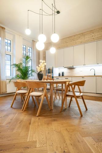 a large kitchen with a wooden table and chairs at Sting Old Town Ostrava in Ostrava