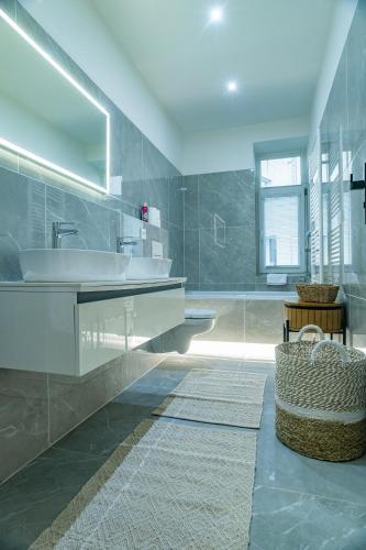 a large bathroom with a sink and a tub at Sting Old Town Ostrava in Ostrava