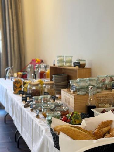 a long table filled with jars of food and bread at Bramslevgaard in Hobro