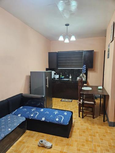 a living room with a couch and a table at Mel's Place Batangas Unit 2 Two Bedroom House w Free Parking WIFI Smart TV Netflix Hot & Cold Shower in Batangas City