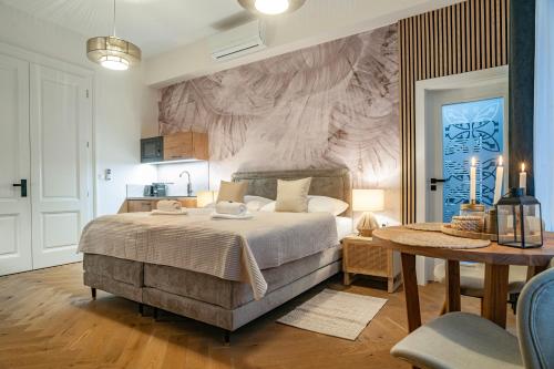 a bedroom with a large bed and a table at Sting Old Town Ostrava in Ostrava