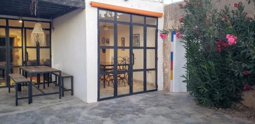 an open door to a patio with a table and chairs at RIAD BERBERE in Taghazout