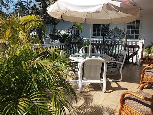 a table and chairs and an umbrella on a patio at Hotel Contadora in Contadora