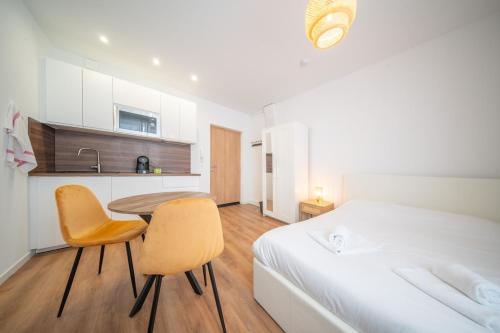 une chambre avec un lit, une table et des chaises dans l'établissement Super Appartement Near Basel 2 personnes 4, à Saint-Louis
