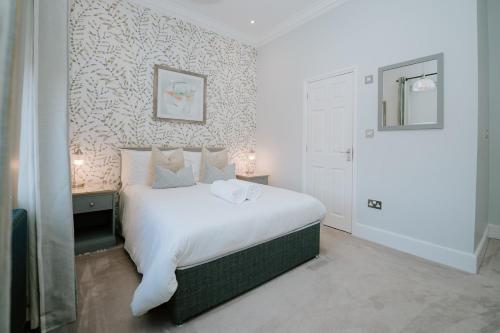 a bedroom with a large white bed in a room at First Light Hotel Lowestoft in Lowestoft