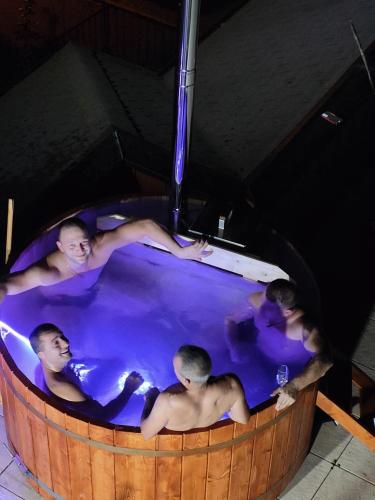 a group of men in a hot tub at Miuti Residence in Triberg