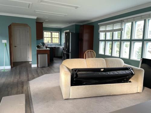 a living room with a couch with a bag on it at Waterwheel Plaza Penthouse Downtown Douglas in Juneau