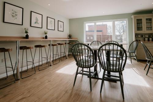 a dining room with chairs and a table in a room at First Light Hotel Lowestoft in Lowestoft