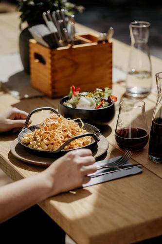 a table with a plate of food and a bowl of food at Forsthaus Wartenfels in Thalgau