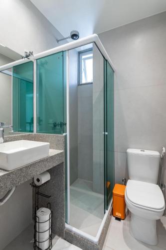 a bathroom with a glass shower and a toilet at Lapa Chêca Guest House in Rio de Janeiro