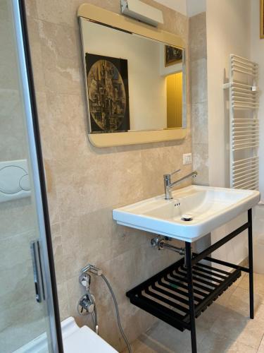 a bathroom with a sink and a mirror at La Riva Sinistra in Rome