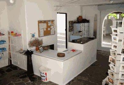 a kitchen with a counter and a mirror in a room at Agistri Club Hotel in Skliri
