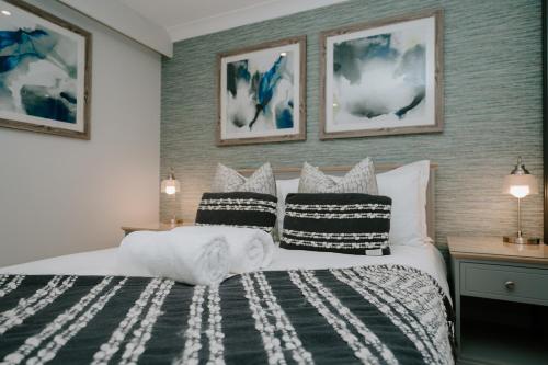 a bedroom with a bed with pillows on it at First Light Hotel Lowestoft in Lowestoft