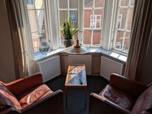 a room with two chairs and a table in front of a window at Restaurant Backhaus in Ribe
