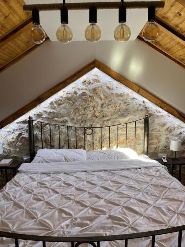 a bedroom with a large bed in a attic at Stone House Chico in Ljubuški