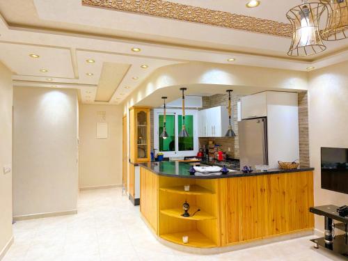 a kitchen with a large island in a room at Complexe touristique City Center Oued Laou - Pool & Play area in Oued Laou