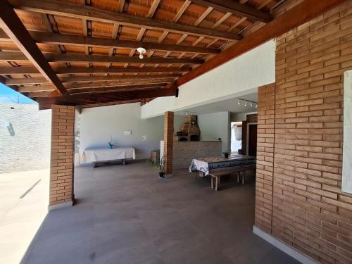 a large living room with a brick wall at CASA LORETO hospedagem, festas e eventos in Taubaté