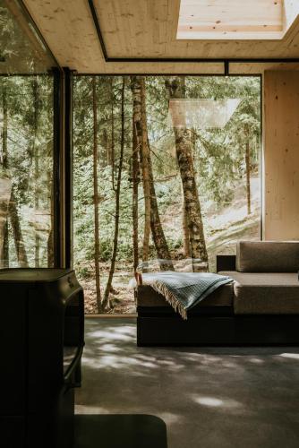 a bedroom with a bed in front of a large window at Laagen in Steinsholt