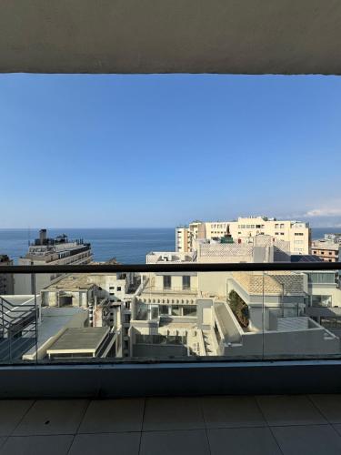 a view of the ocean from a balcony of a building at Ny Suites in Beirut