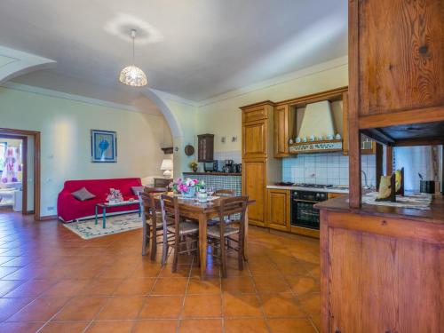 a kitchen and living room with a table and chairs at Apartment L'Uccelliera-2 by Interhome in Canneto