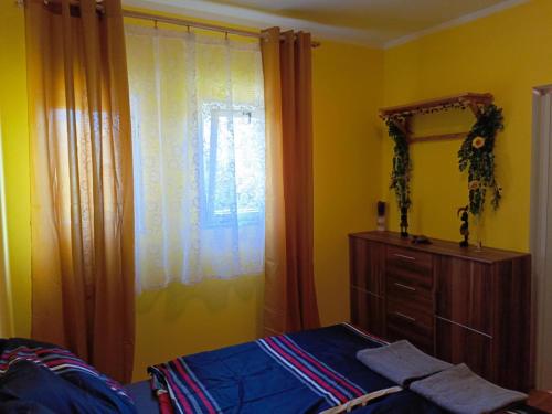 a bedroom with a bed and a dresser and a window at Vířivka u Křemílka in Němčovice