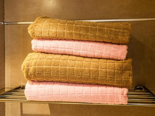 a pile of towels on a rack in a bathroom at Apartment RoSol Albir Playa in Albir