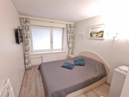 Postel nebo postele na pokoji v ubytování Girulių apartamentai prie jūros
